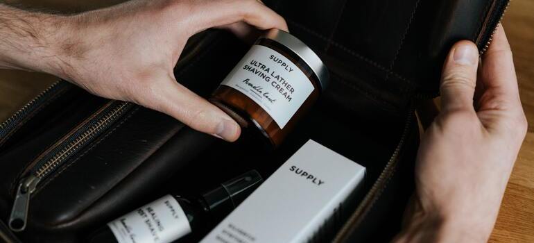 person packing shaving kit