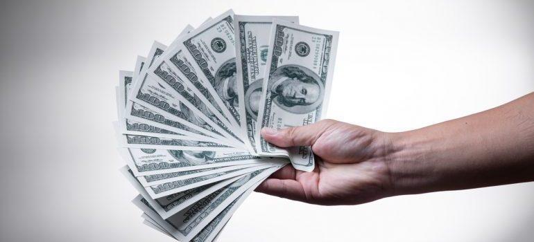 A person holding a heap of money