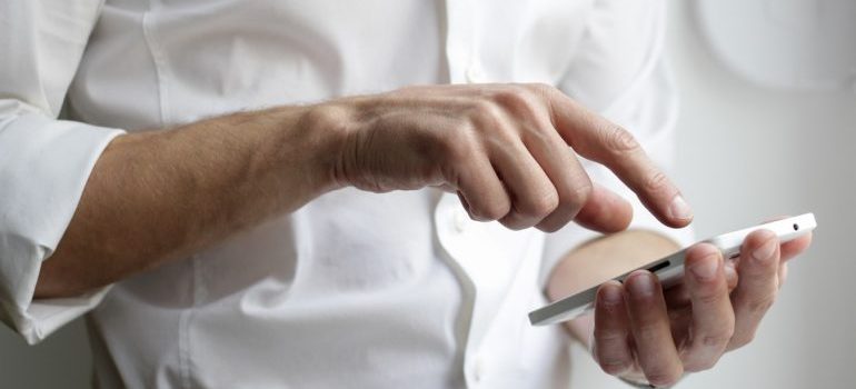 A man dialing a number on his phone