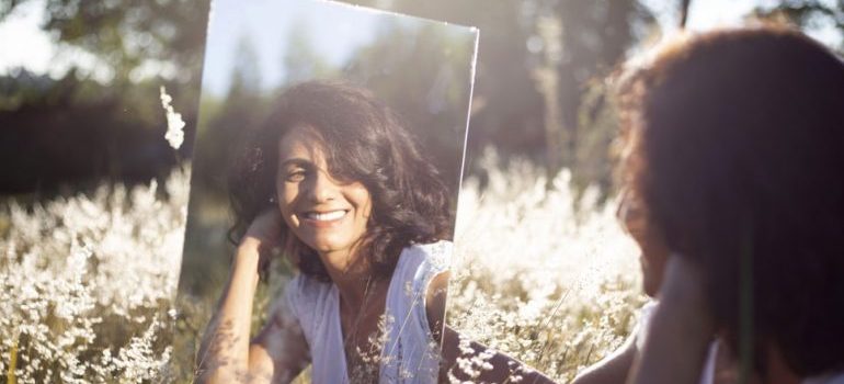 A woman holding a mirror