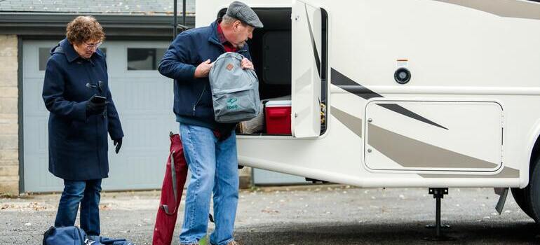 person putting bags in the truck
