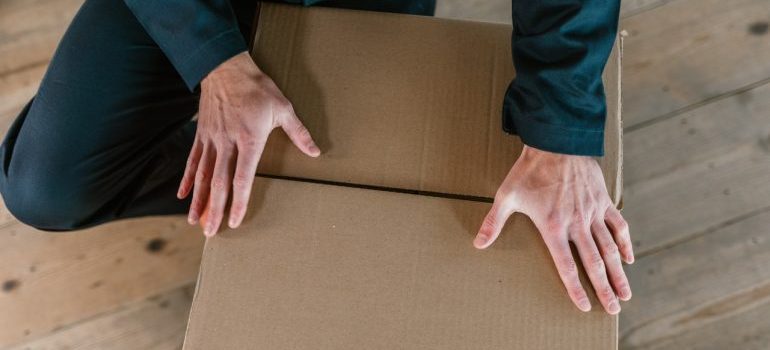 Person packing a box