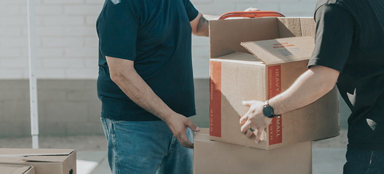 two men exchanging boxes