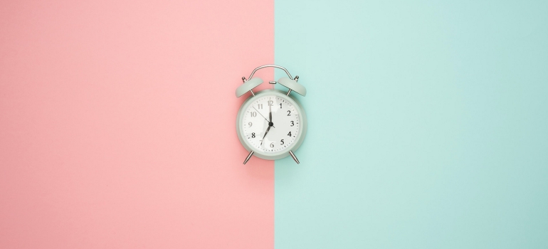 a clock on a pink and teal background