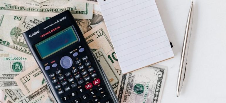 calculator, pen, notebook, money 