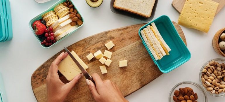 person preparing food, lunch box