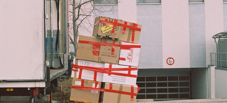 Brown cardboard boxes on gray asphalt road