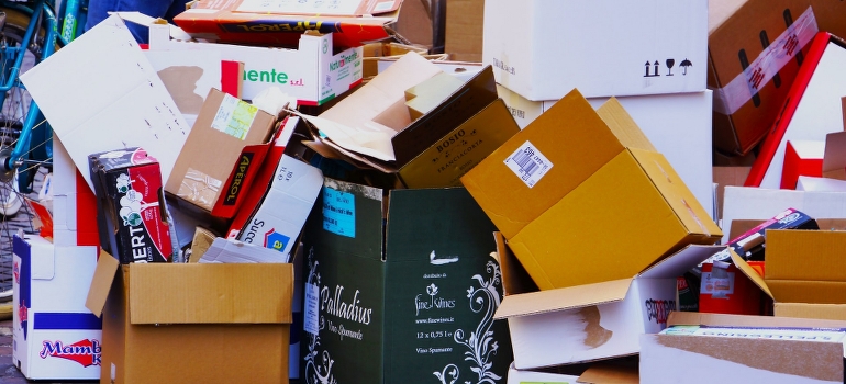 looking at a pile of boxes and thinking about plastic moving crates vs. cardboard boxes