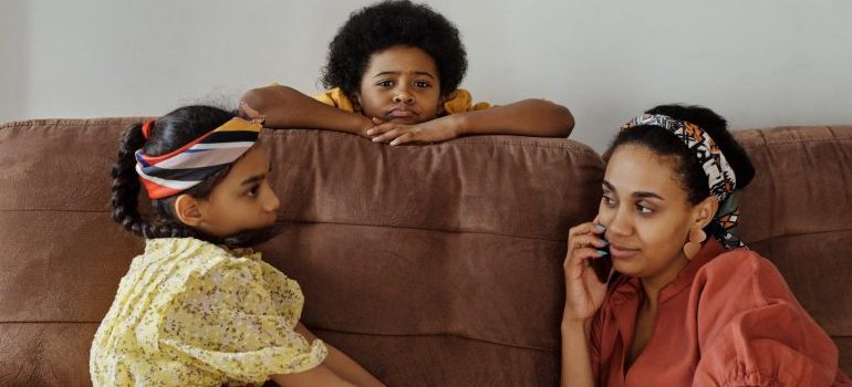 woman and two kids on a sofa