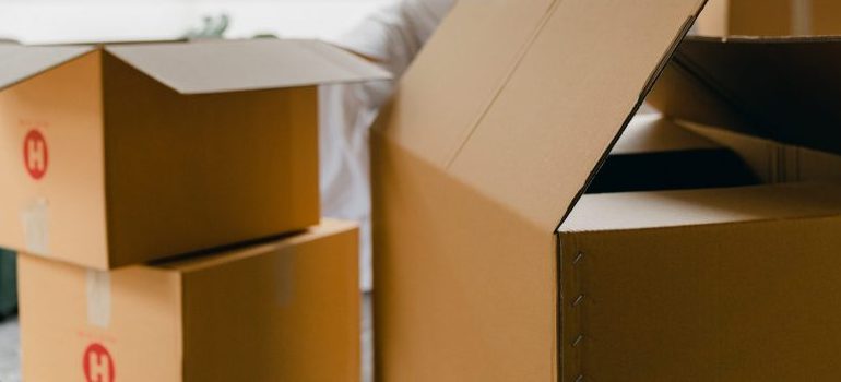 unpacked boxes in middle of room