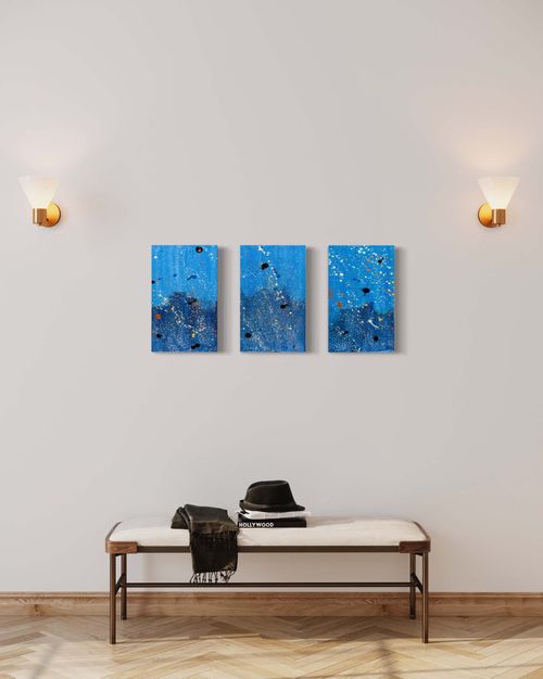 'Beneath the Unknown' is a 3-panel abstract painting featuring blue acrylic paints with gold, bronze, white, and black splatters. The painting invites the viewer to explore its hidden depths, and it's perfect for any modern home or office space. It adds sophistication and elegance to any room and is a true masterpiece.