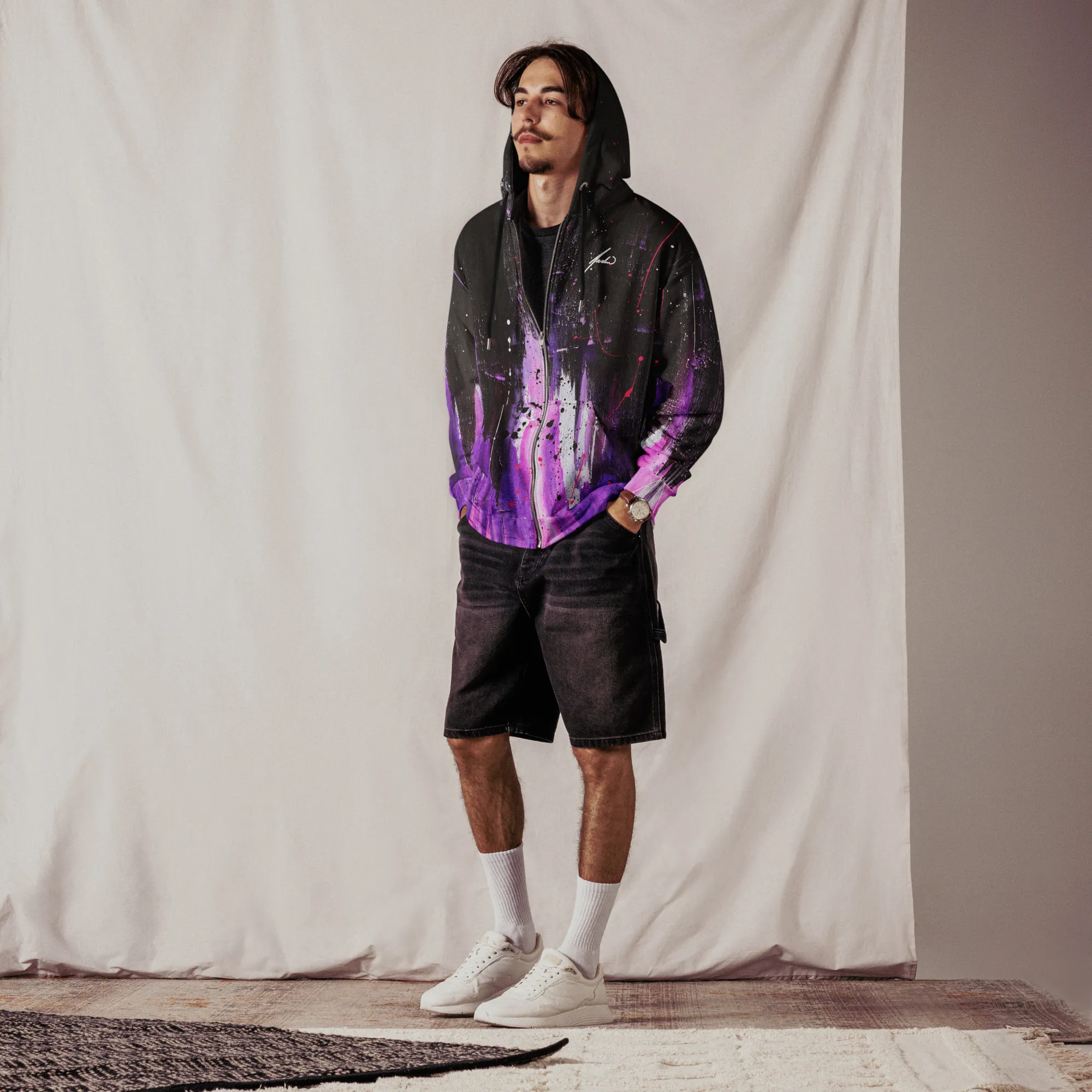 A man wearing a zip hoodie with a front view, showcasing the Andrew Hatfield logo and artwork inspired by 'Dreambound' original painting.