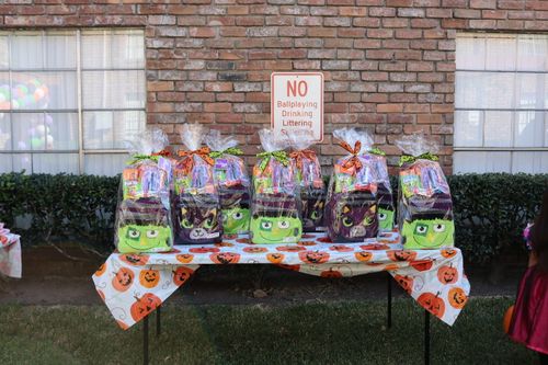 Halloween goody bags for the community appear on a table in the courtyard for Villa Feliz apartments.