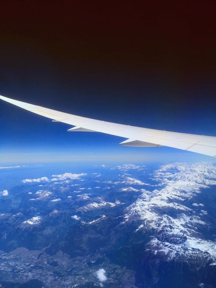 Picture from a plane showing the plane wind flying over the Alps