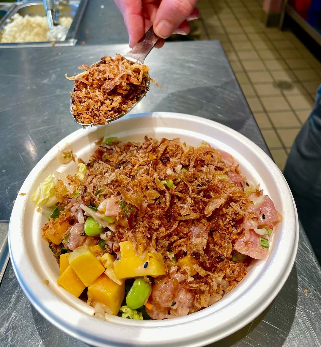  Sweetfin’s poke bowl, garnished with a spoonful of crispy onions. 