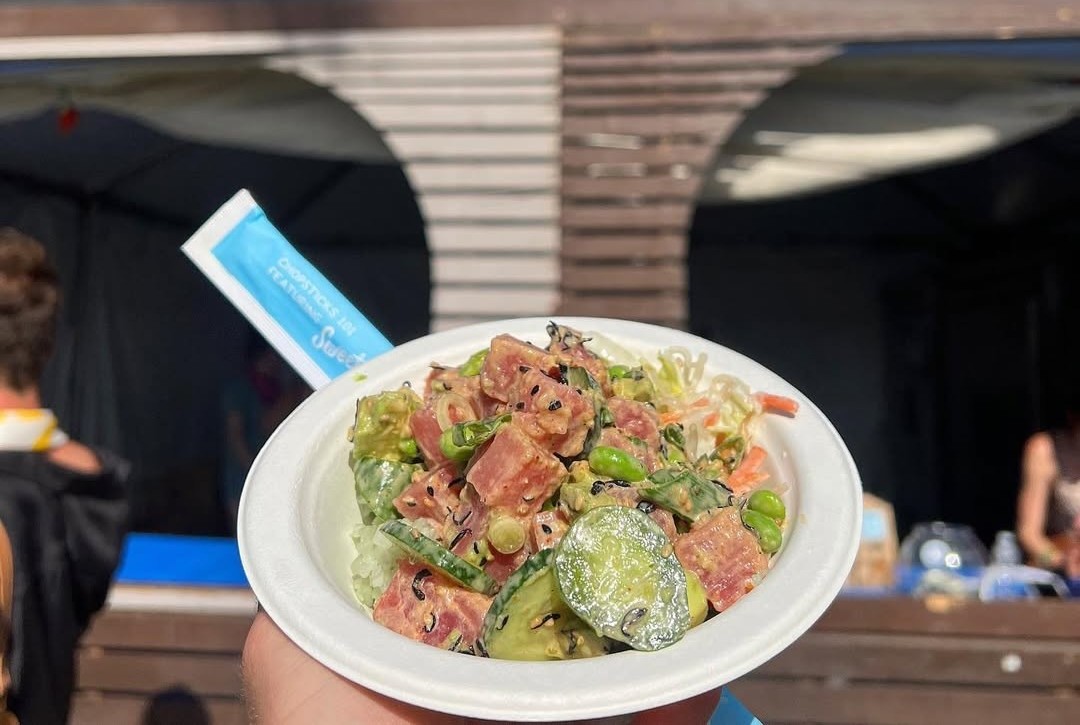 A person holding a poke bowl from Sweetfin.