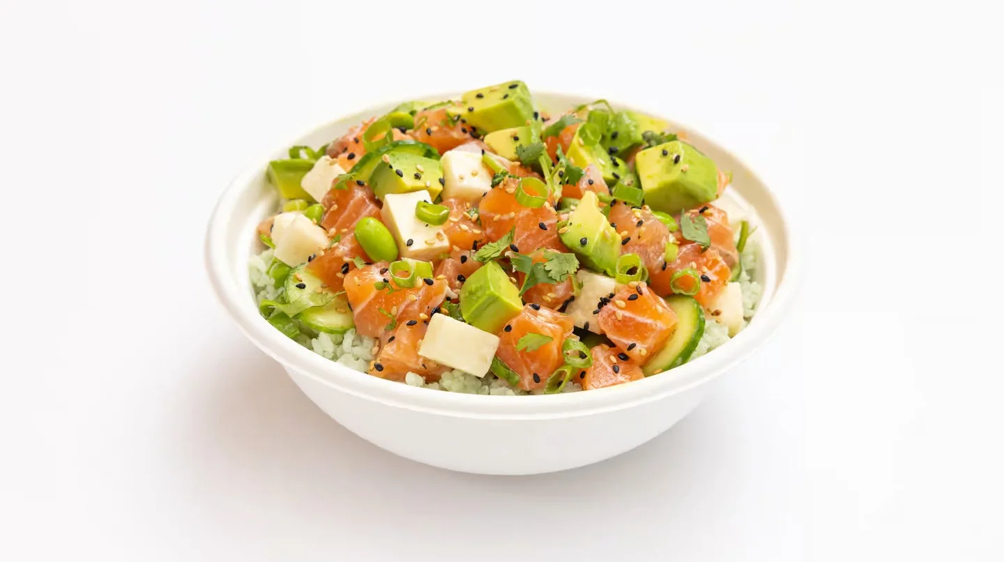 Sweetfin Yuzu Salmon Poke Bowl with salmon, avocado, edamame, cucumber, jicama, cilantro, and yuzu kosho sauce.