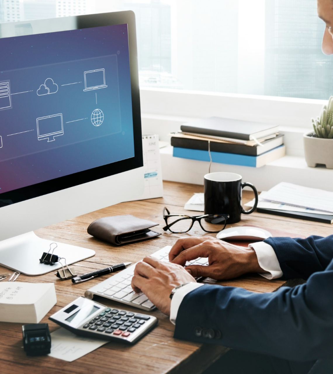 Man working on the desktop to plan the cloud migration and testing.
