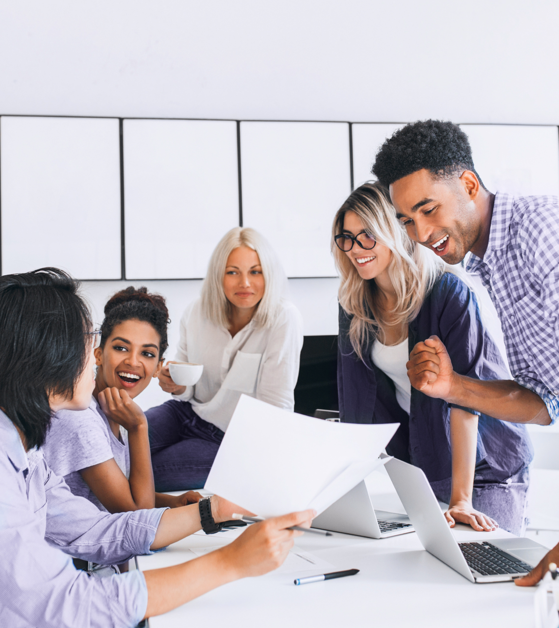 The corporate team of five looks happy about the success and results.
