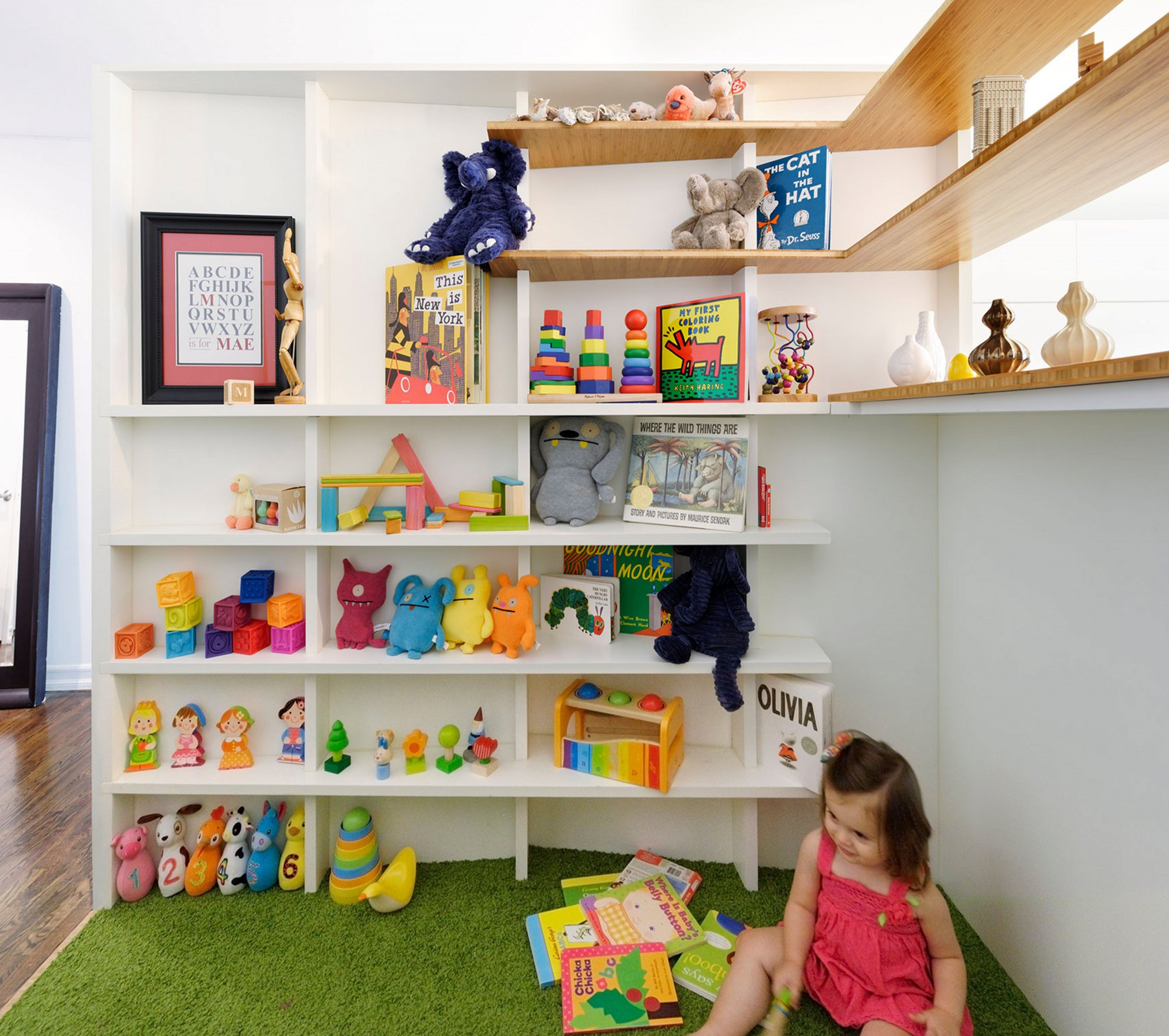 The skeletal structural system of the 'Cloud‑Catcher' doubles as shelving for toys and books
