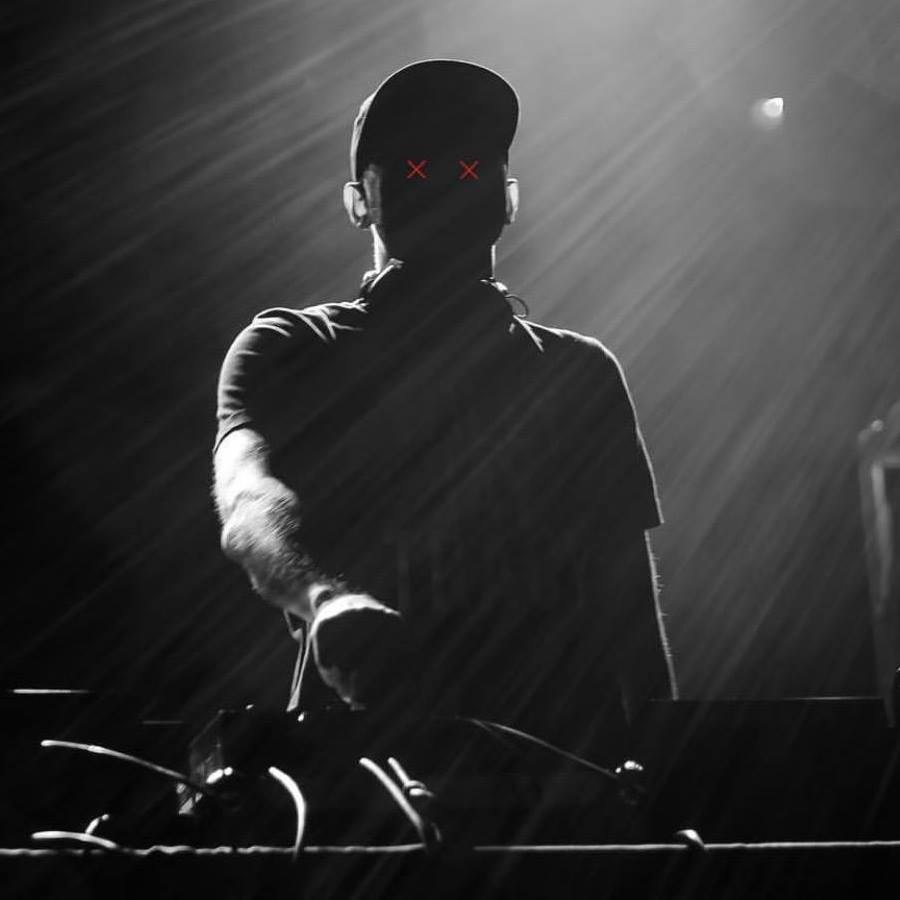 Portrait of dj MACFIE standing over turntables