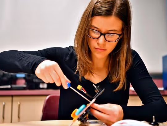 A U.S. high school student assembling her drone.