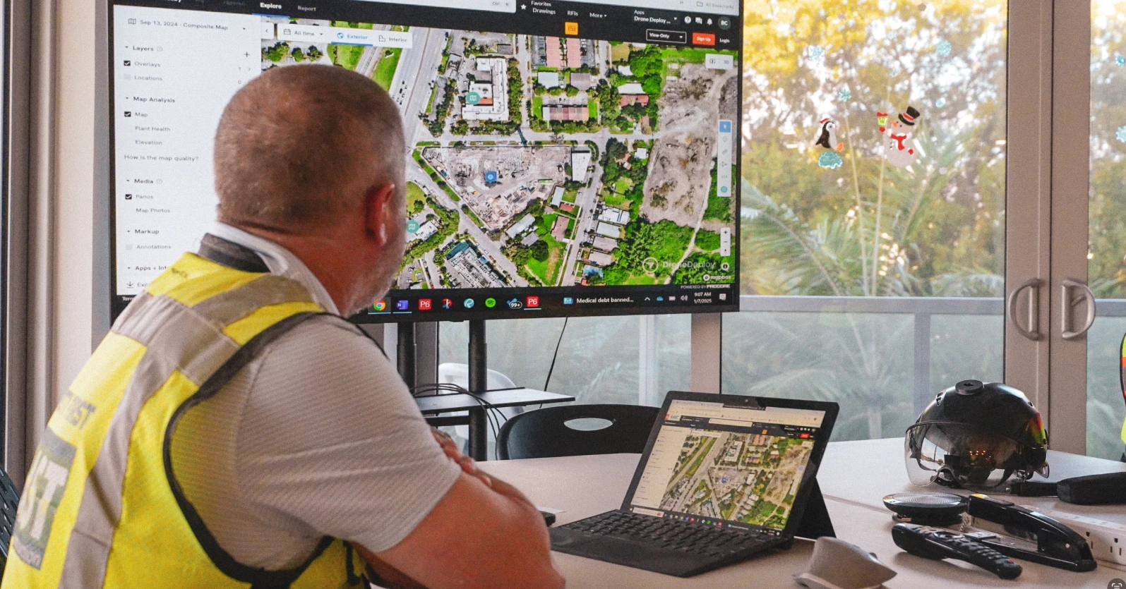 construction worker viewing jobsite in a drone map