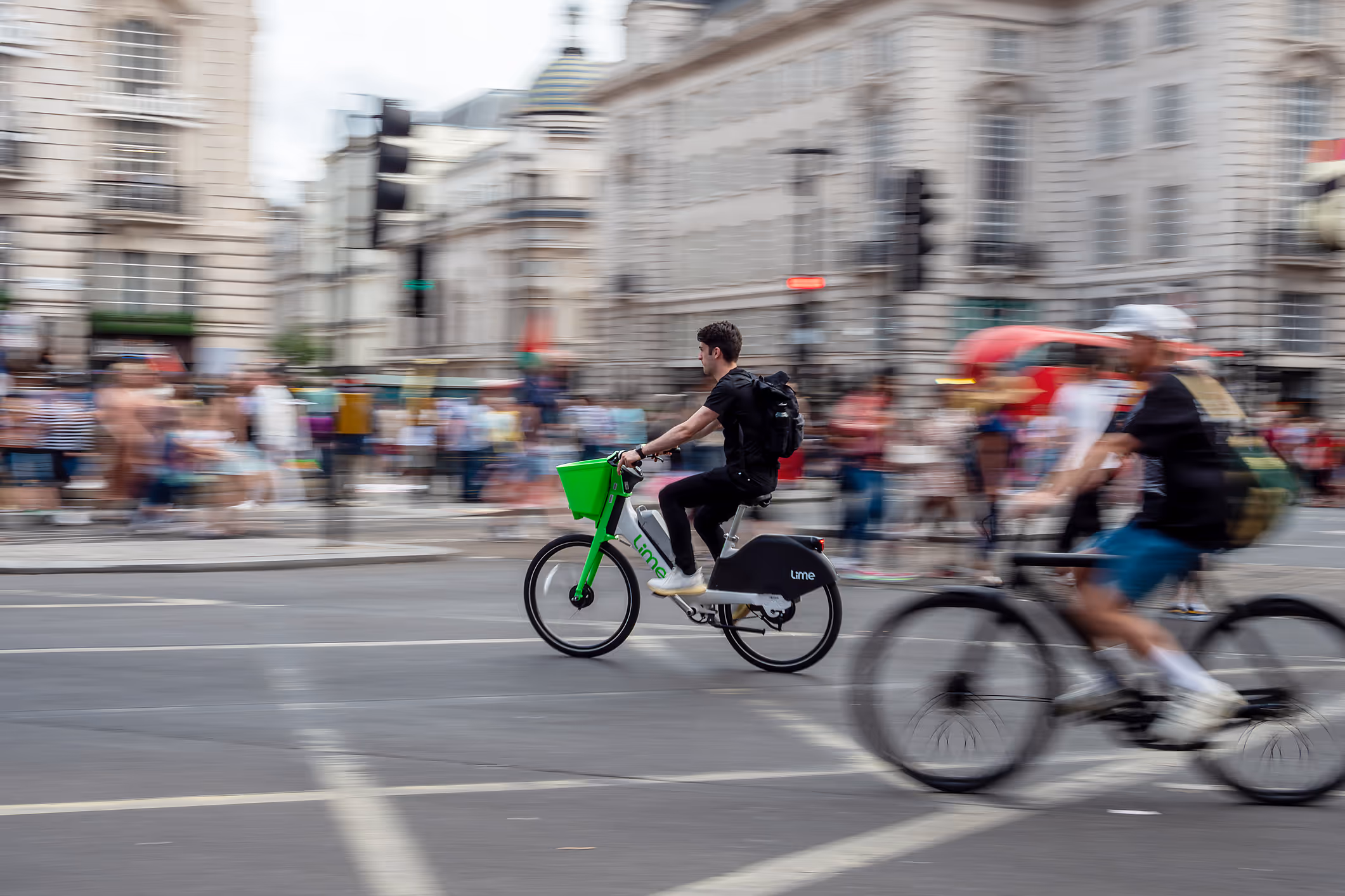 Man travelling through central London on a lime bike