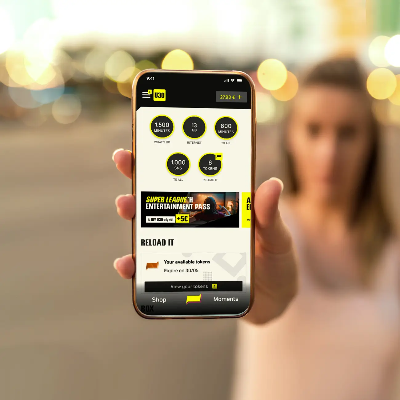 Person holding a smartphone displaying the What's up homepage.