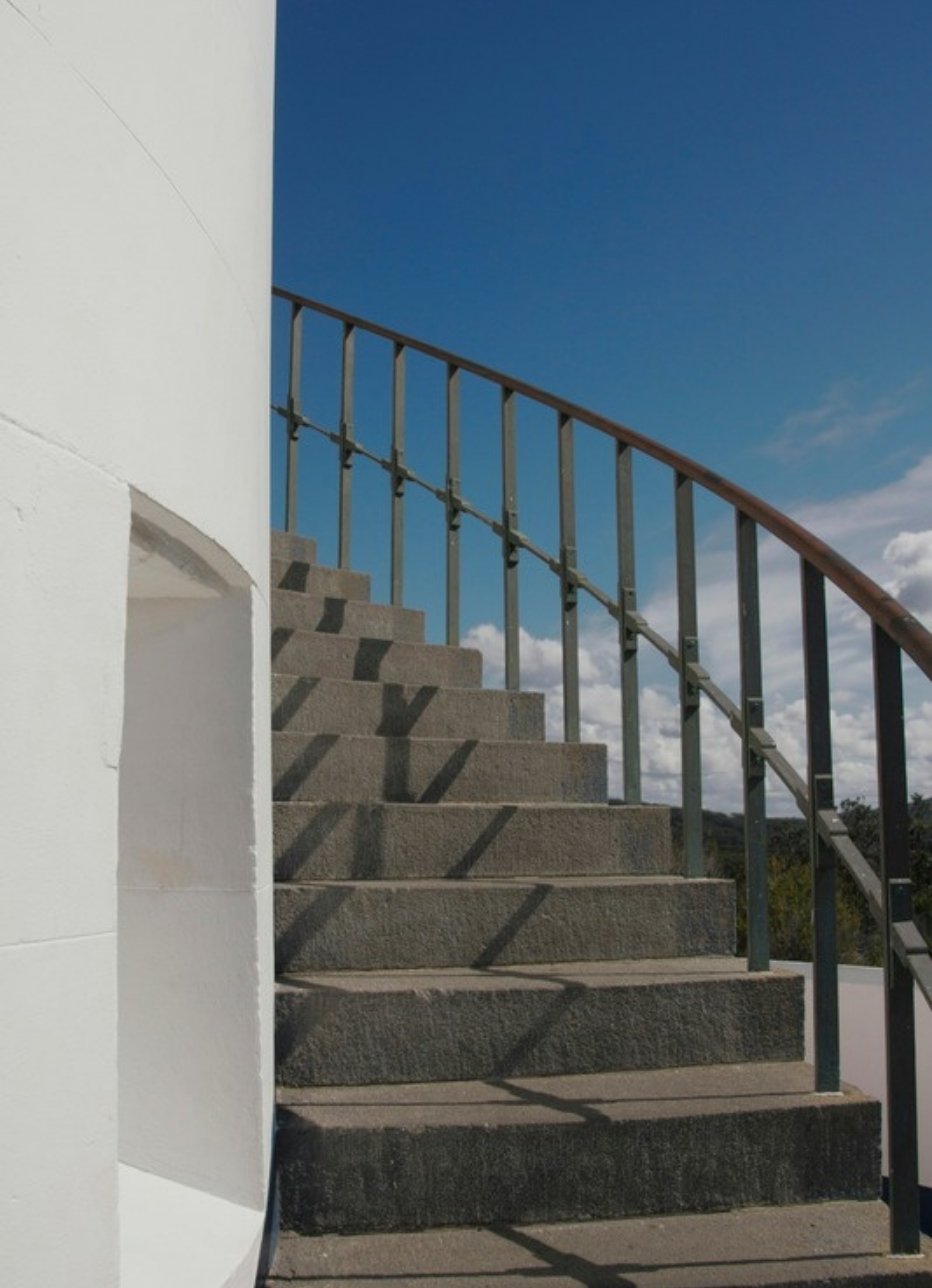 White concrete staircase rising against a blue sky, photo by Jennefer Zacarias