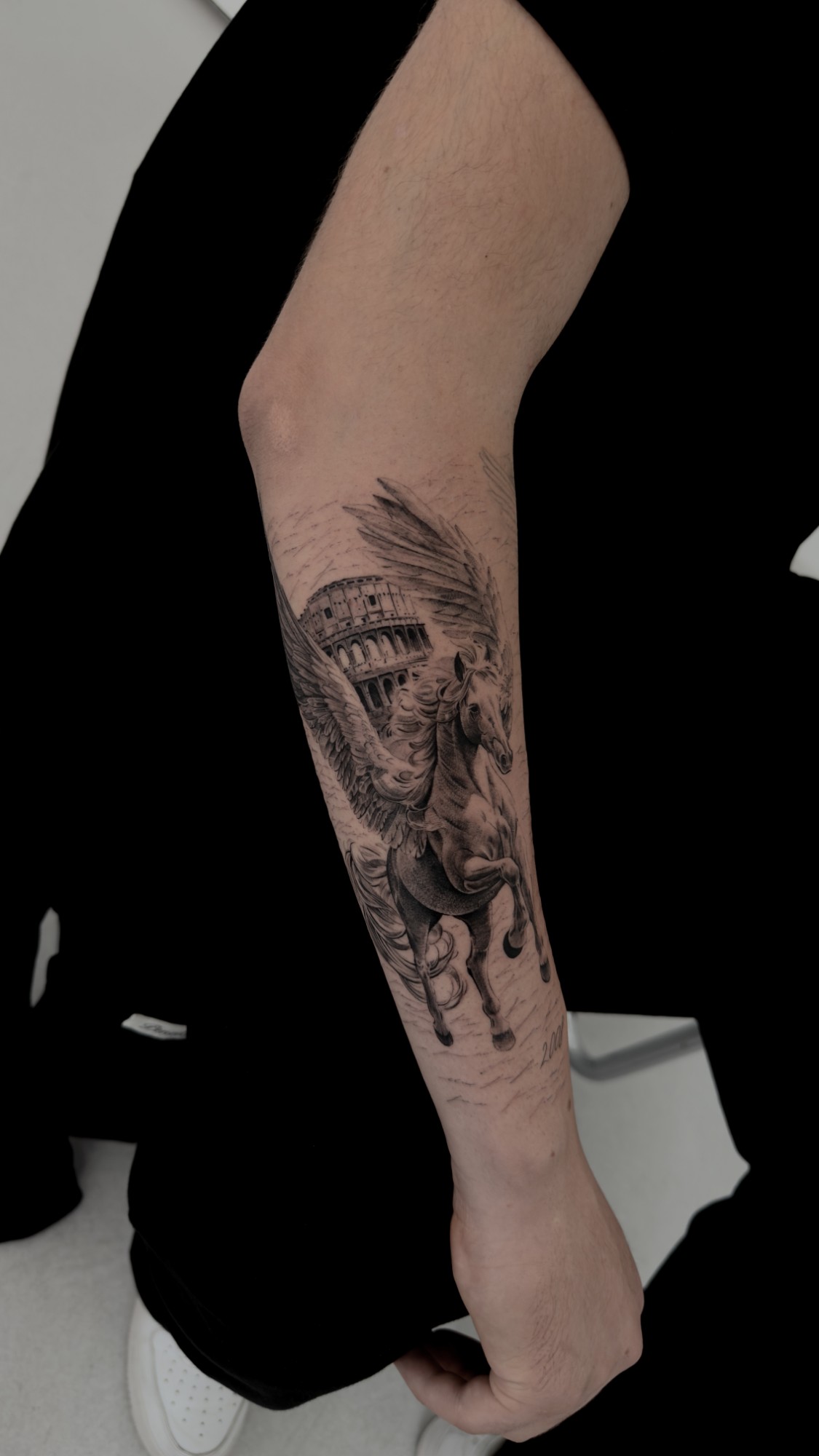Black and grey pegasus and Colosseum tattoo