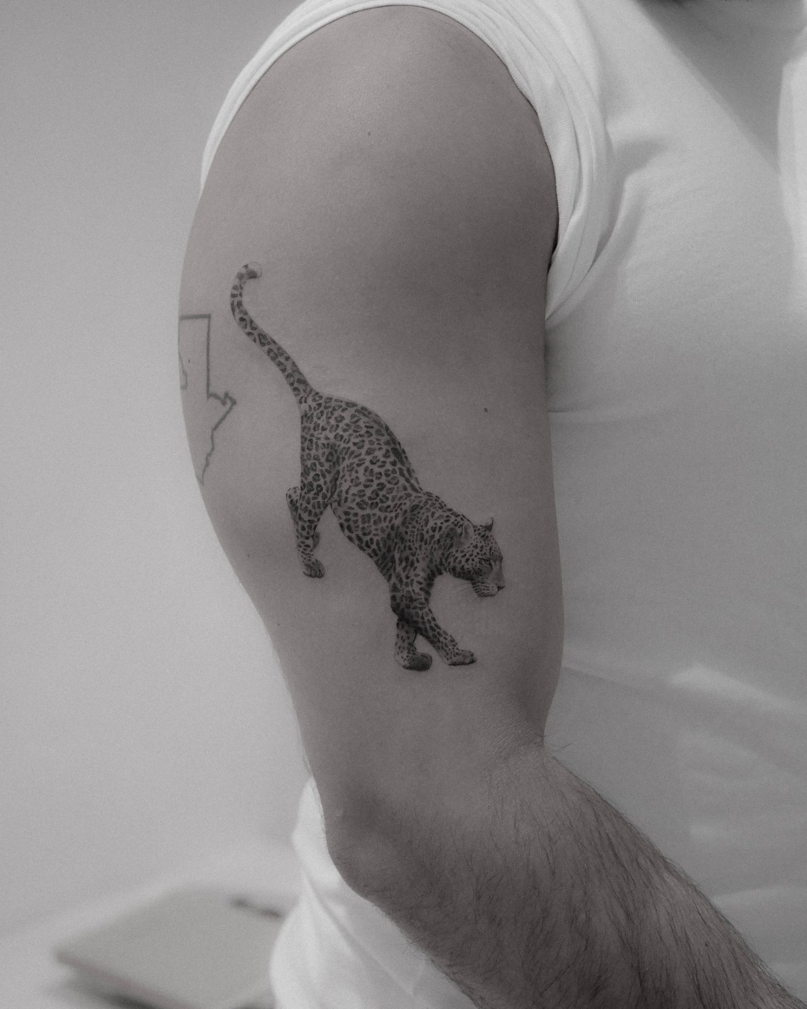 Black and grey leopard arm tattoo