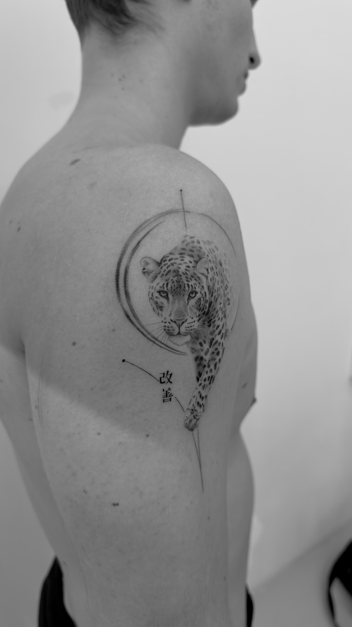 Black and grey leopard tattoo