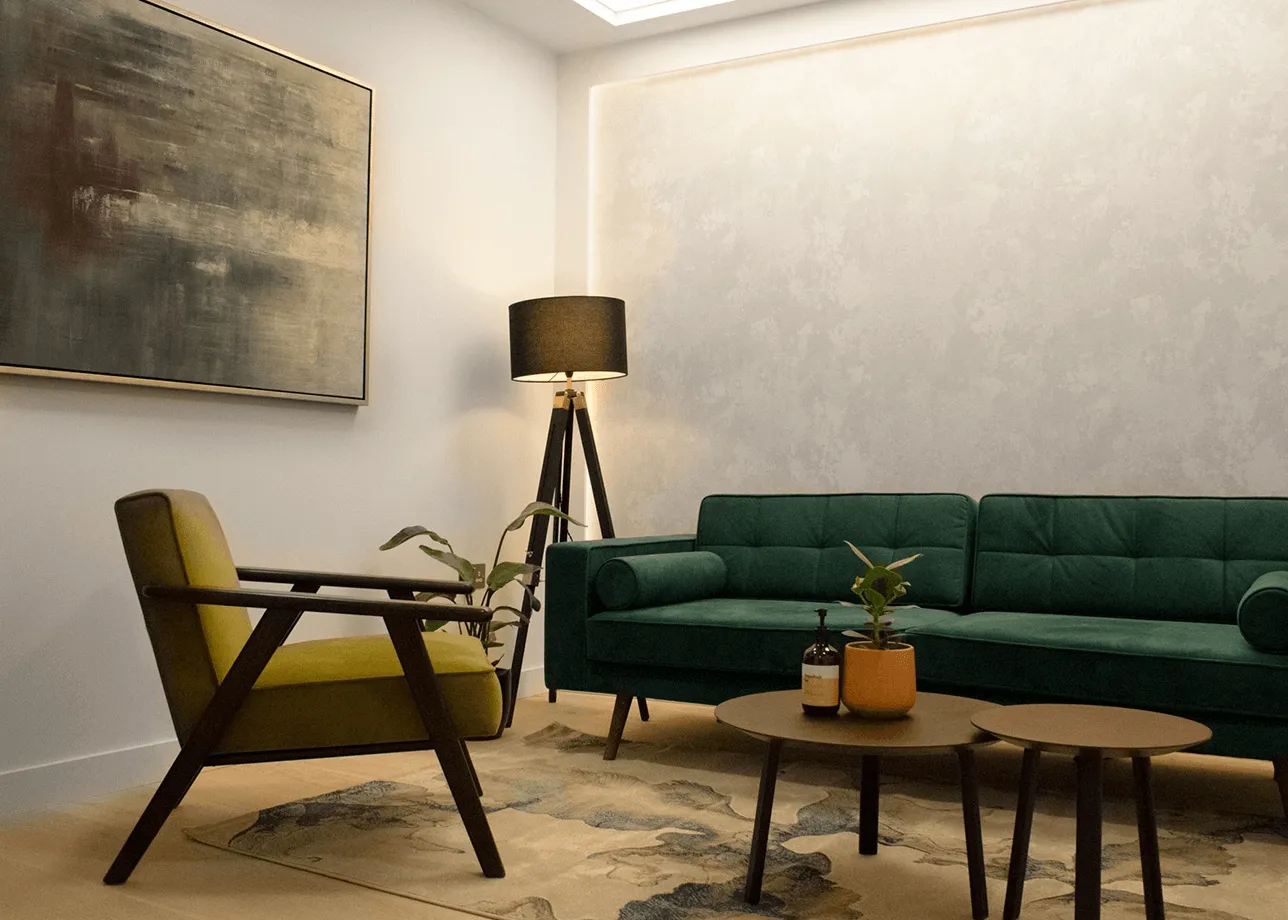 Modern living room with green velvet sofa, mustard armchair, round coffee tables, floor lamp, and abstract wall art.