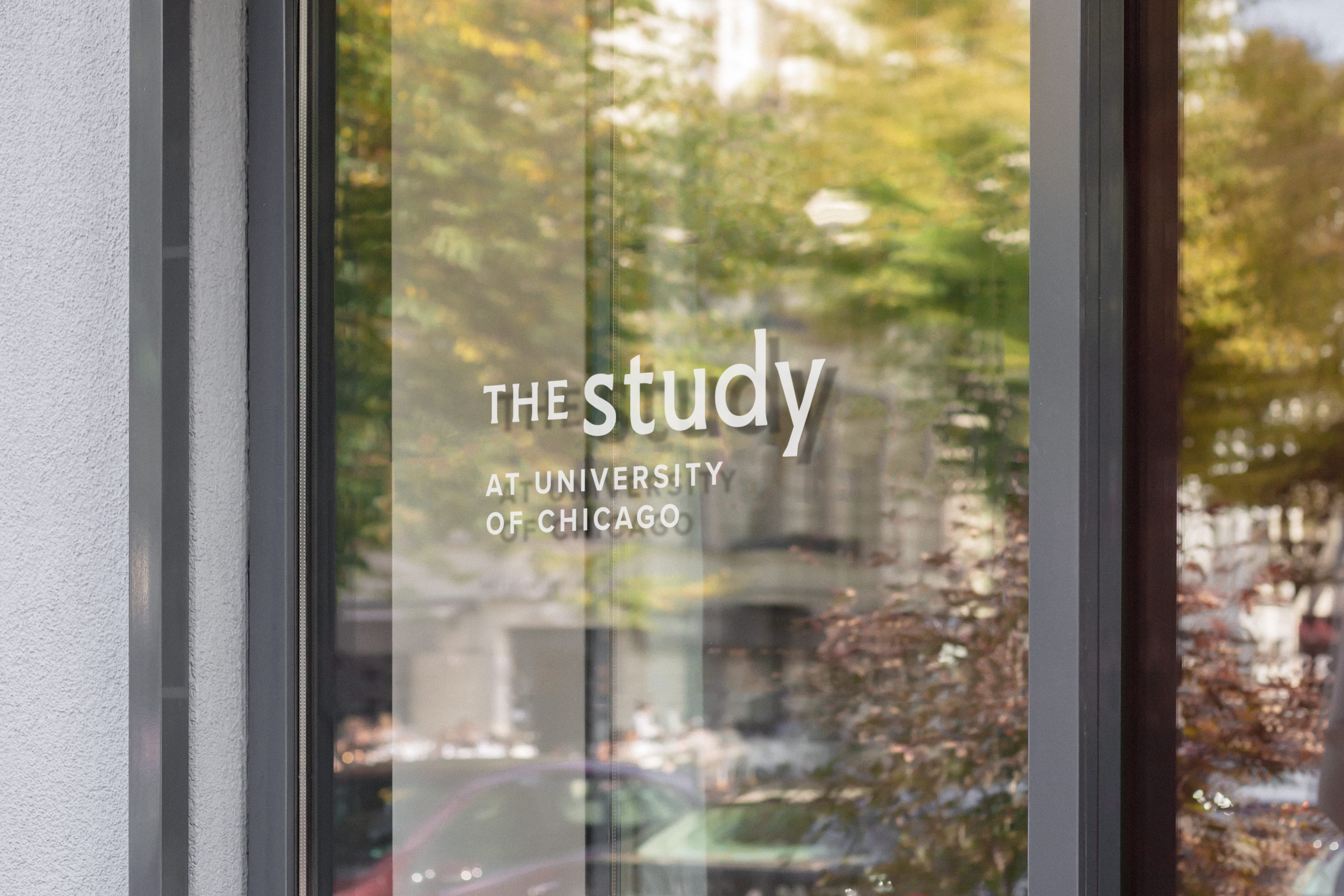 White vinyl lettering on glass window reads "The Study at University of Chicago"