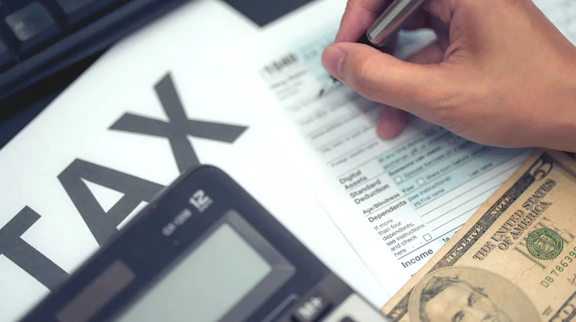 paper tax forms with calculator