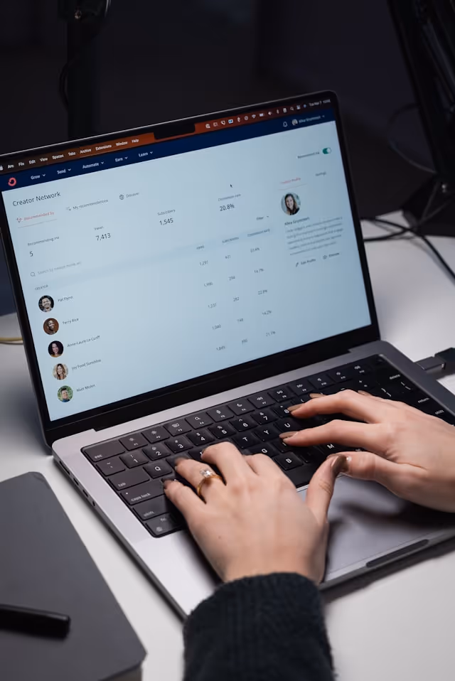 A woman tapping on the keyboard of her laptop
