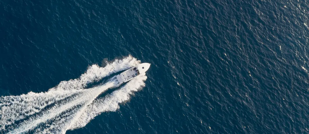Aerial view of a boat, high speed. Drone tech impact many industries, a new perspective.