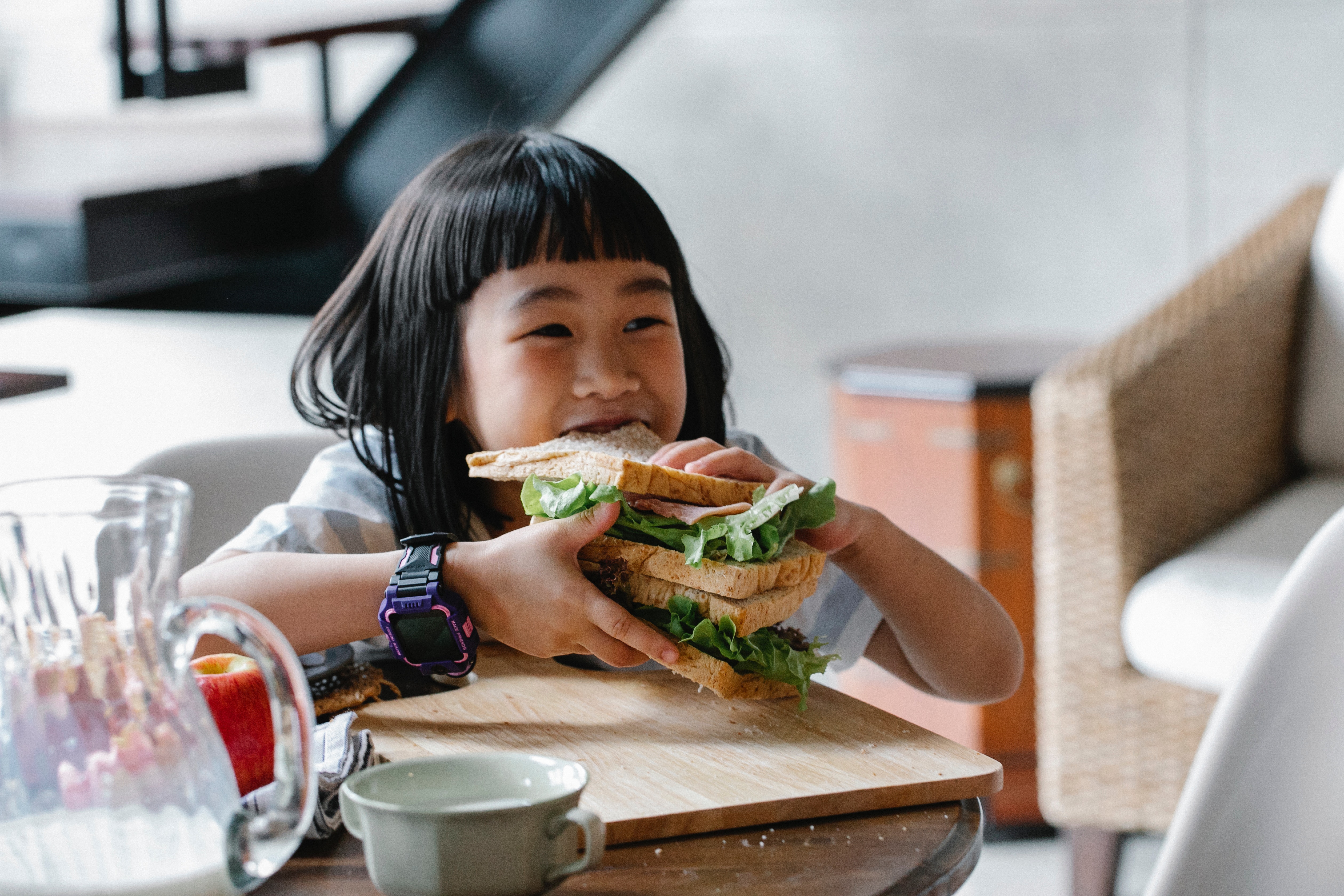 Child eating a very large sandwich