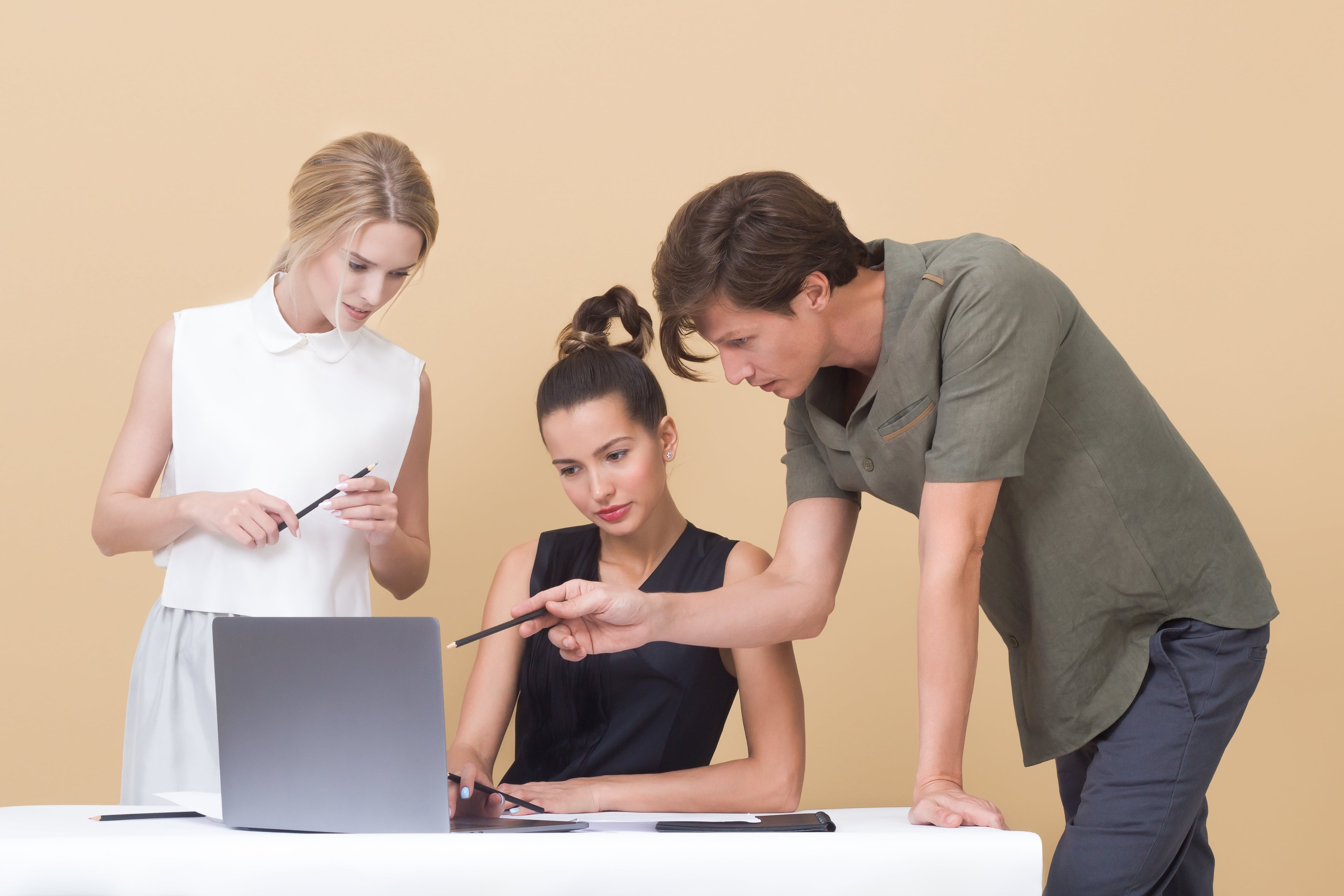 People gathered around a laptop