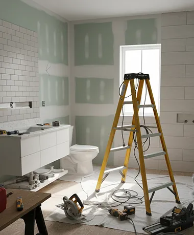 Bathroom remodeling scene with ladder, tools, and partially installed fixtures