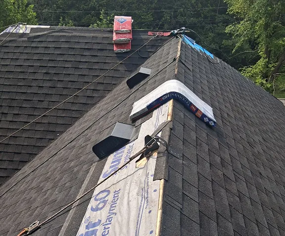 Residential roof installation in Chicago with workers applying underlayment