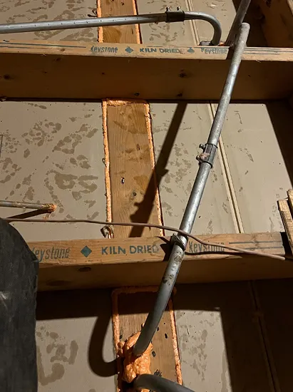 Air sealing attic floor seams and penetrations with spray foam for energy efficiency