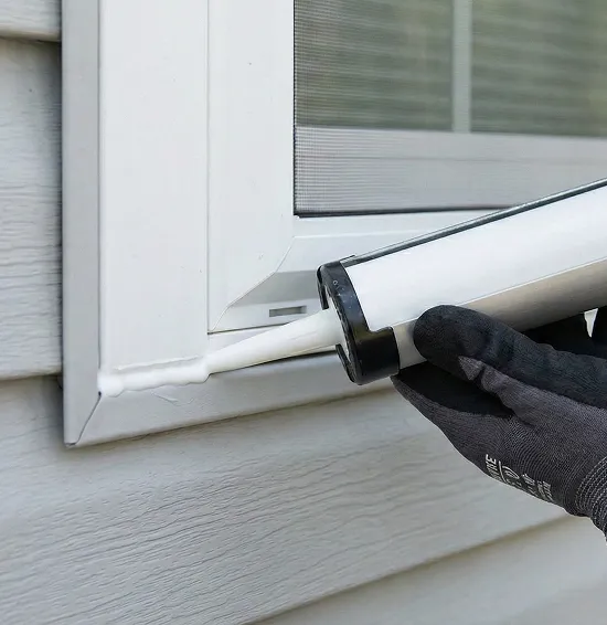 Close-up of exterior window caulking sealing a gap to stop drafts