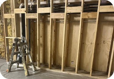 Close-up of wall framing and plumbing lines ready for spray foam