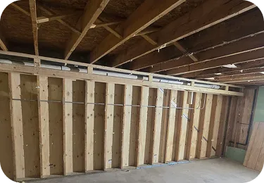 View of unfinished wooden wall studs in a Glenview basement