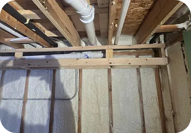 Detail of freshly applied spray foam insulation on a Glenview basement wall