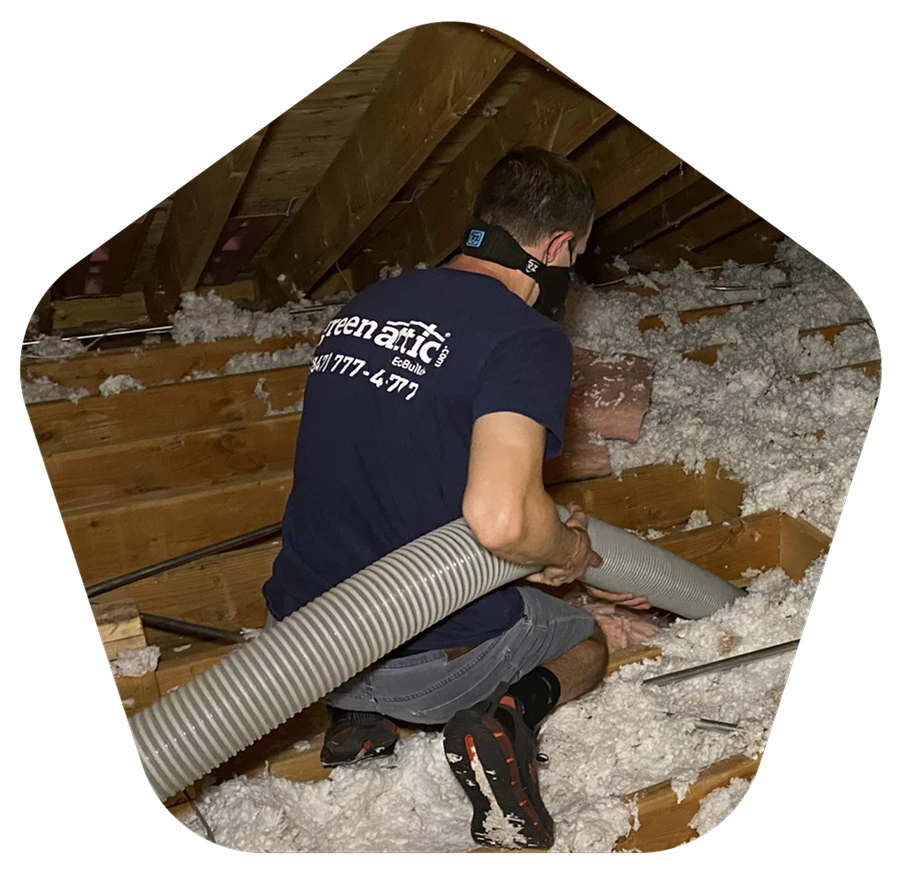 Green Attic Insulation technician removing old attic insulation in Chicagoland home