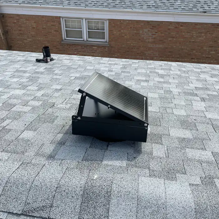 Solar-powered attic ventilation fan installed on a shingle roof by Green Attic Insulation in Chicago