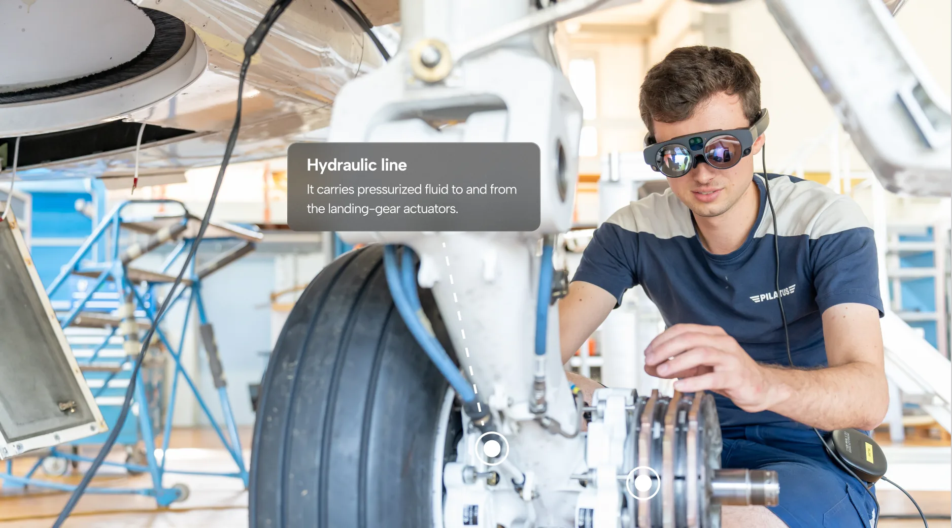 a man using AR headset for airplane maintenance work